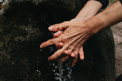 Midsection of man holding water