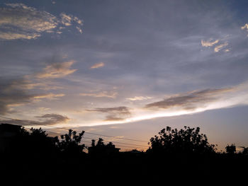 Silhouette trees against sky during sunset