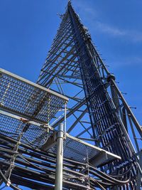 Low angle view of tower against blue sky
