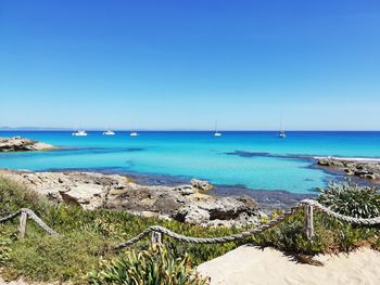 Scenic view of sea against clear blue sky