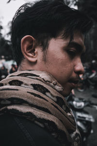 Close-up portrait of young man looking away