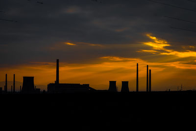 Silhouette buildings against sky during sunset