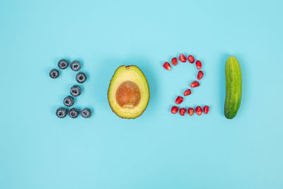 Directly above shot of fruits against blue background