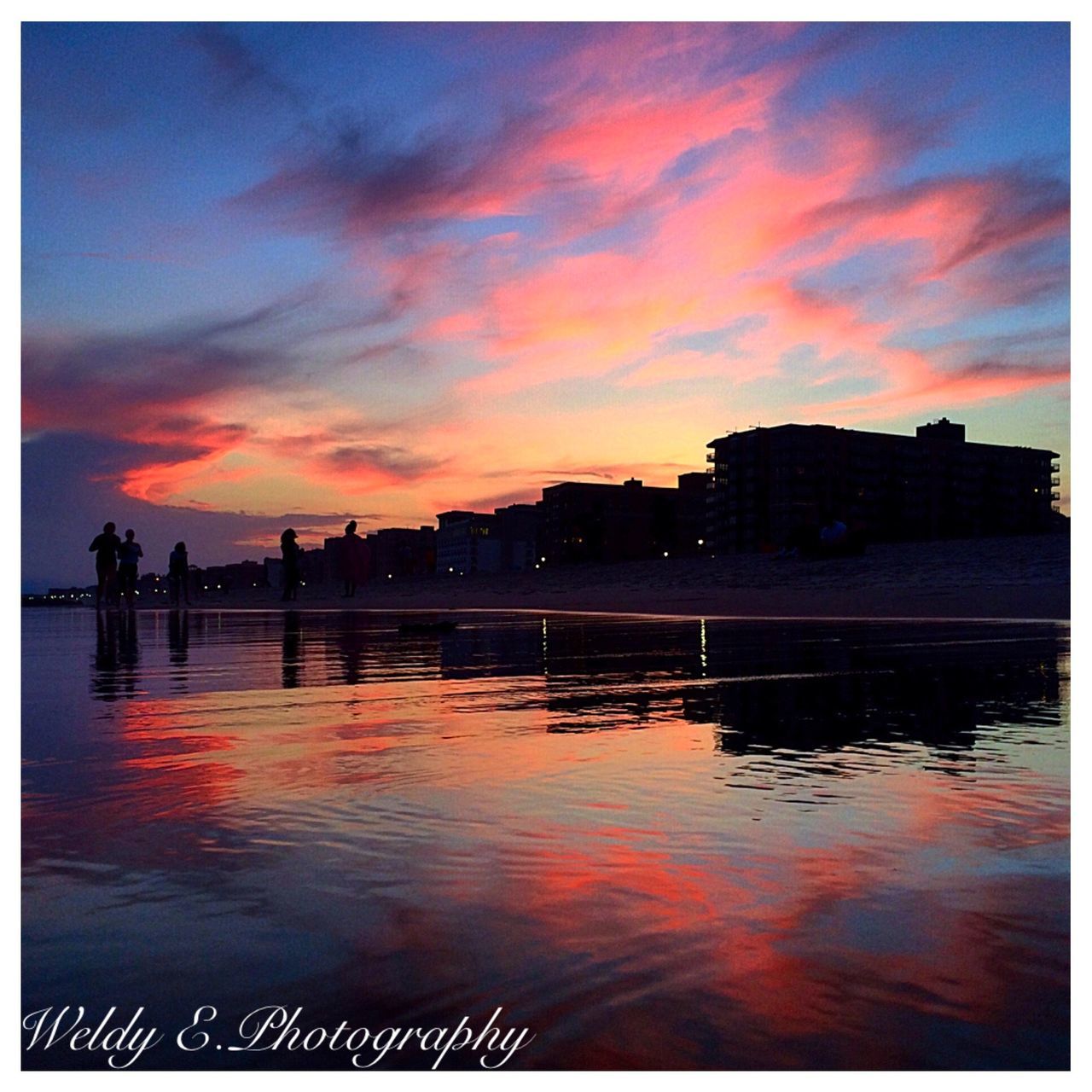 sunset, water, sky, architecture, built structure, orange color, reflection, building exterior, cloud - sky, transfer print, waterfront, auto post production filter, silhouette, scenics, cloud, beauty in nature, dramatic sky, dusk, city, nature