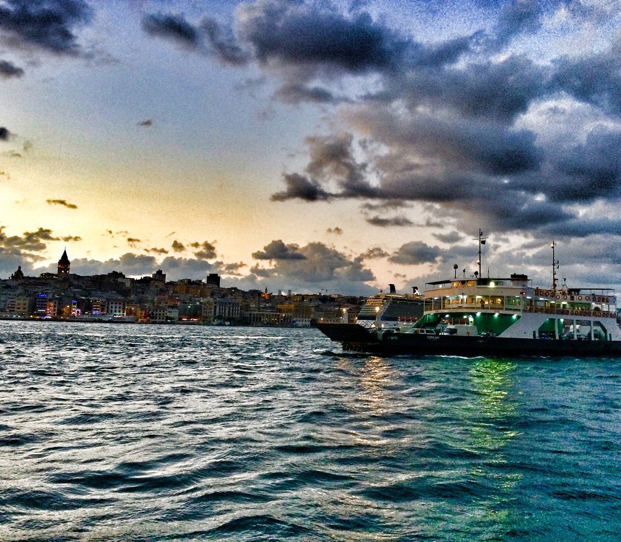 water, waterfront, sky, cloud - sky, sea, cloudy, nautical vessel, transportation, built structure, architecture, mode of transport, building exterior, weather, cloud, overcast, nature, boat, rippled, scenics, storm cloud