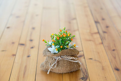 High angle view of flowers in sack on hardwood floor