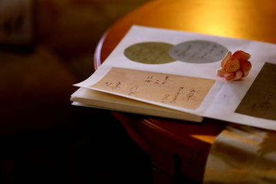 Close-up of cropped book on table