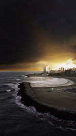 Scenic view of beach against sky during sunset