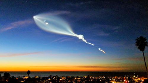 Scenic view of vapor trails in sky at night