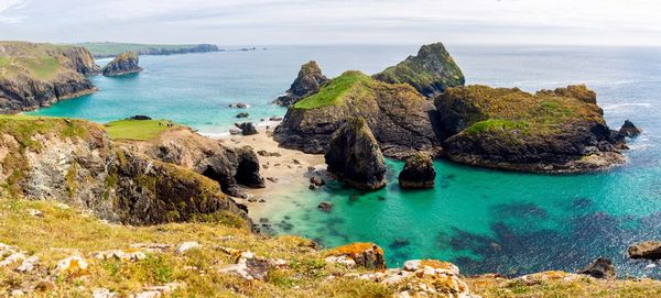 Panoramic view of rocks on sea shore against sky