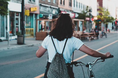 Rear view of woman walking on street in city