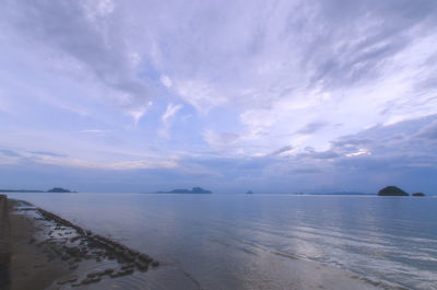 Scenic view of calm sea against cloudy sky
