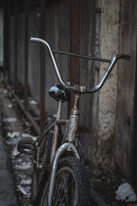 Close-up of bicycle parked in abandoned building
