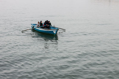 People in boat on sea