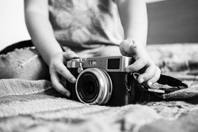 Midsection of woman with camera