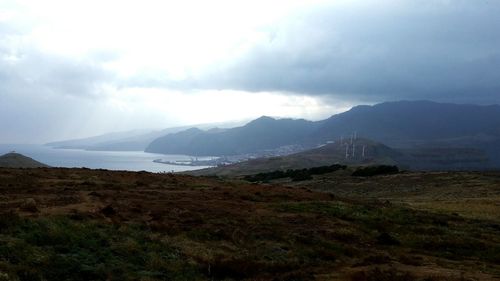 Scenic view of mountains against cloudy sky