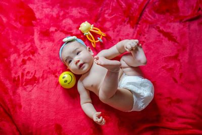 Directly above shot of cute baby lying on bed