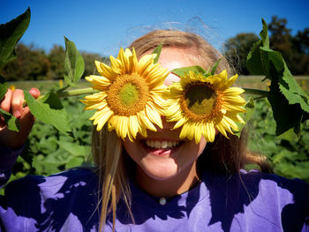 Close-up of smiling woman with flowers