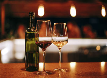 Close-up of wine glasses on table