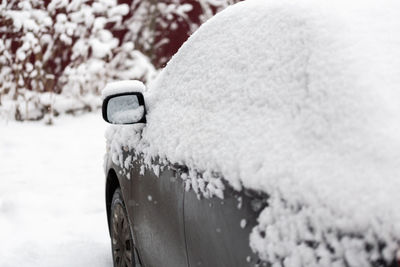 Close-up of snow covered car