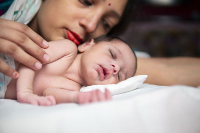 High angle view of young woman sleeping on bed at home