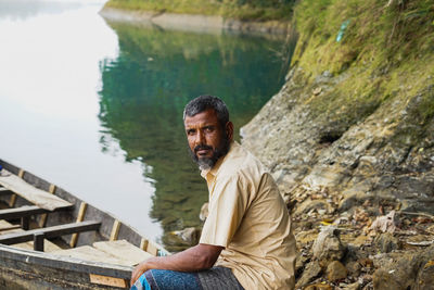 Portrait of young man sitting in water