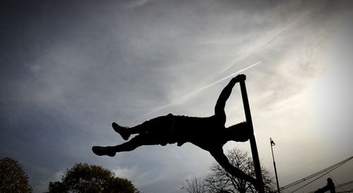 Low angle view of silhouette tree against sky