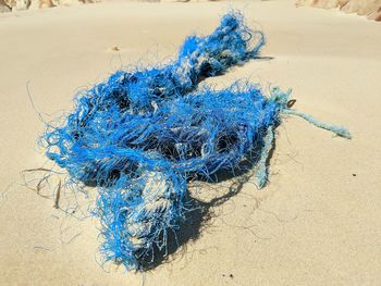 High angle view of blue fishing net on beach