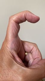 Close-up of human hand against white background