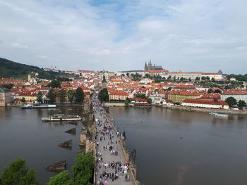 High angle view of townscape by river against sky