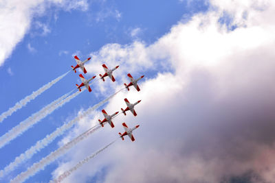 Low angle view of airshow against sky