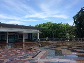 View of swimming pool by building against sky