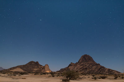 Scenic view of mountains against clear blue sky