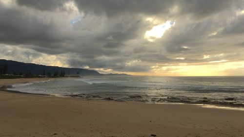 Scenic view of beach against sky during sunset