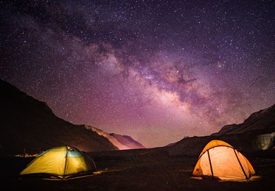 Scenic view of illuminated mountains against sky at night