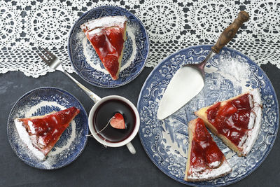 Valentines day, red strawberry pie on blue plates and a gift in a red box