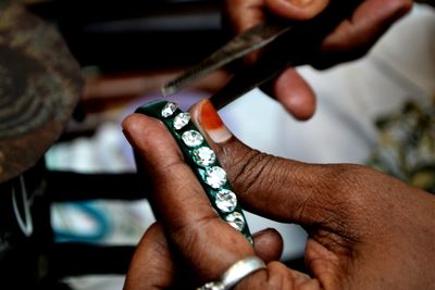 Cropped image of hand holding cigarette