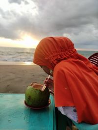 View of person holding leaf on beach