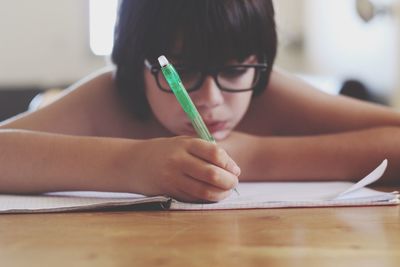 Close-up of woman writing in notebook