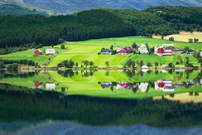 Scenic view of houses by lake