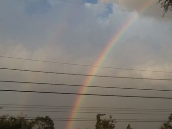 Low angle view of rainbow against sky