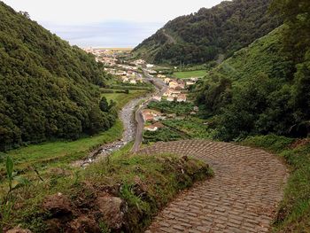 Pathway amidst green mountains