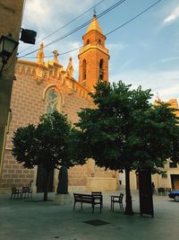 Trees and buildings against sky