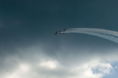 Low angle view of airplane flying against sky