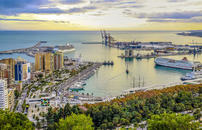 High angle view of cityscape by sea against sky