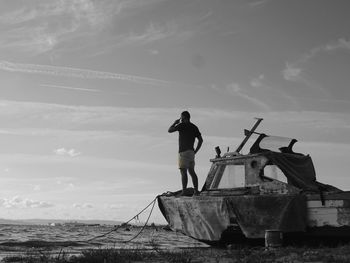 Full length of man standing on abandoned boat