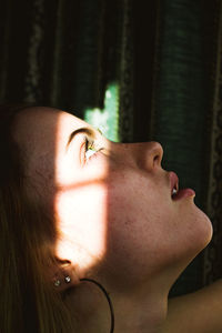 Close-up of woman looking up at into sunlight