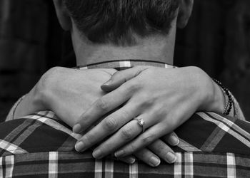 Rear view of man touching hair