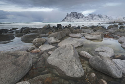 Pebbles on beach against sky