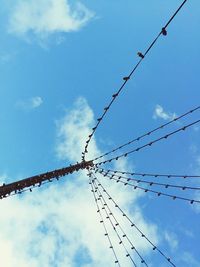 Low angle view of fairy lights against blue sky